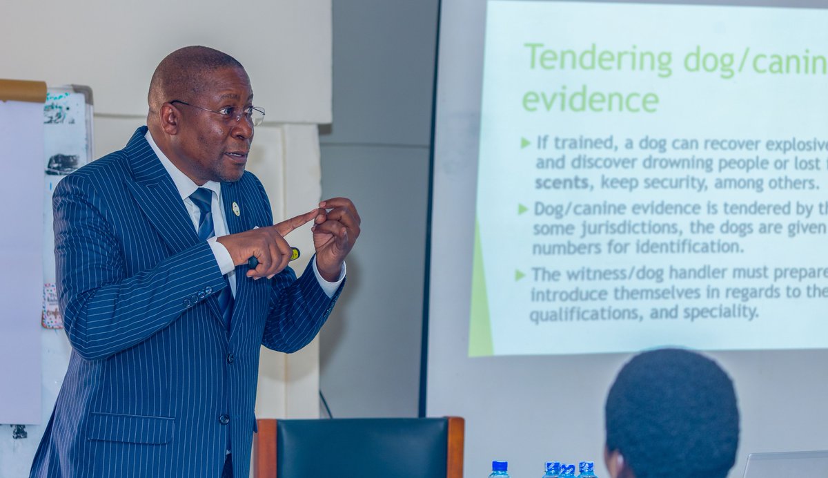 PoliceUg's tweet photo. Justice Duncan Gaswaga of the High Court’s International Crimes Division yesterday engaged 30 officers undertaking the Basic K9 Induction Course at the Police Canine Unit Headquarters in Nsambya, delivering a lecture on the legal principles governing the admissibility and exclusion of canine evidence in court.

During the lecture, he emphasised the need for professionalism, thorough preparation and integrity in handling and presenting canine-generated evidence. He cautioned the officers against bias, corruption and falsification of reports, noting that credible and properly presented evidence is essential to the administration of justice.