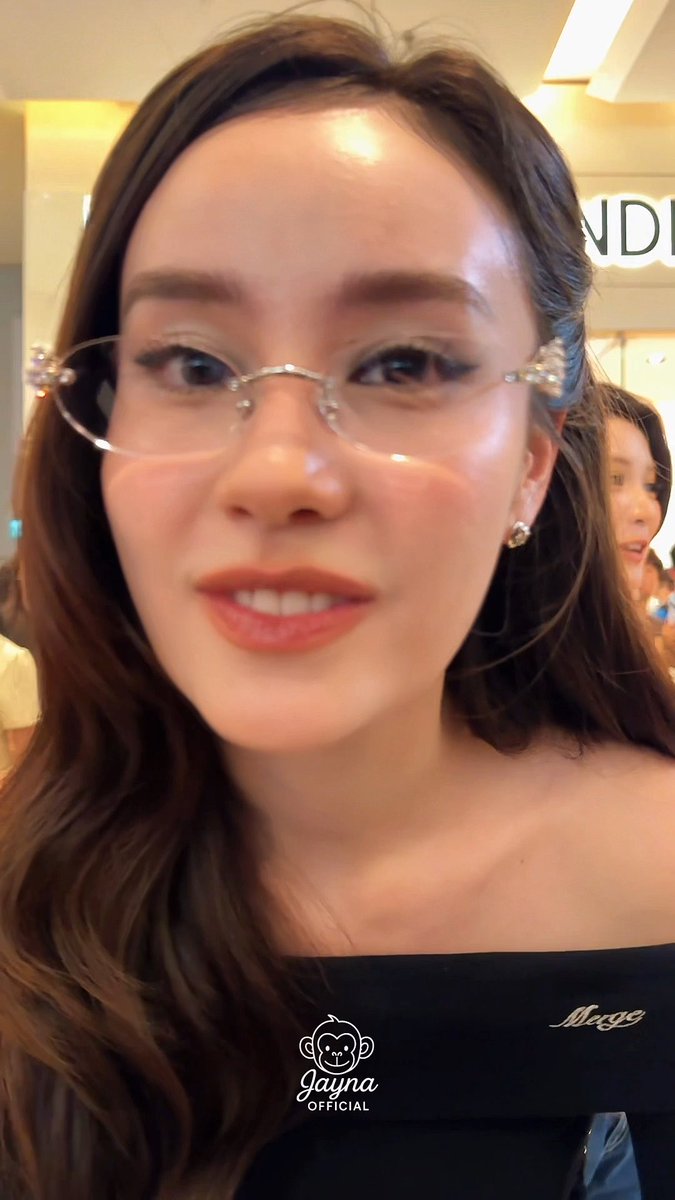 Close-up selfie of a woman wearing decorative glasses, with 'Jayna OFFICIAL' and 'Meggy' watermarks visible.