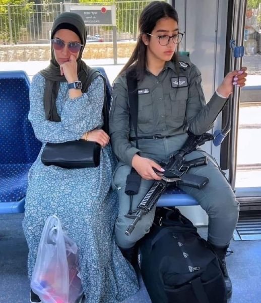 YaarGhadimi's tweet photo. Don't fall for it!

You only see peace in this photo because the Israeli girl is the one holding the gun.
If that gun was in the girl on the left's hand, you'd be looking at a scene from #October7. https://t.co/i0PkJyRMzX