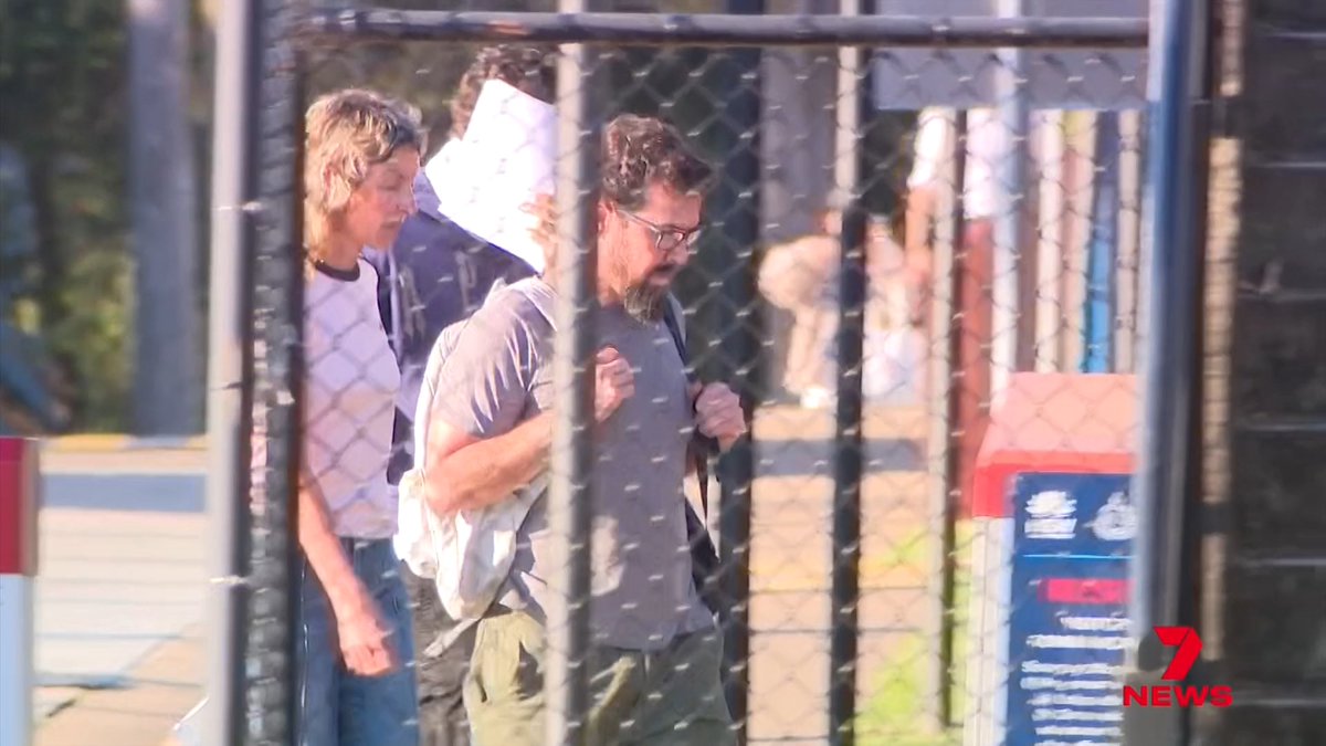 People walk behind a chain-link fence outside a building, with a "7 NEWS" logo visible in the bottom right corner of the frame. The image appears to be b-roll footage accompanying a news story about a young driver being granted bail after allegedly hitting pedestrians.