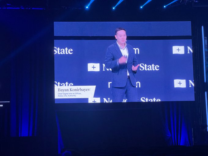 Bayan Konirbayev, Chief Digital and AI Officer of Astana City Authority, presenting on stage at the Next Generation / +Nation conference.
