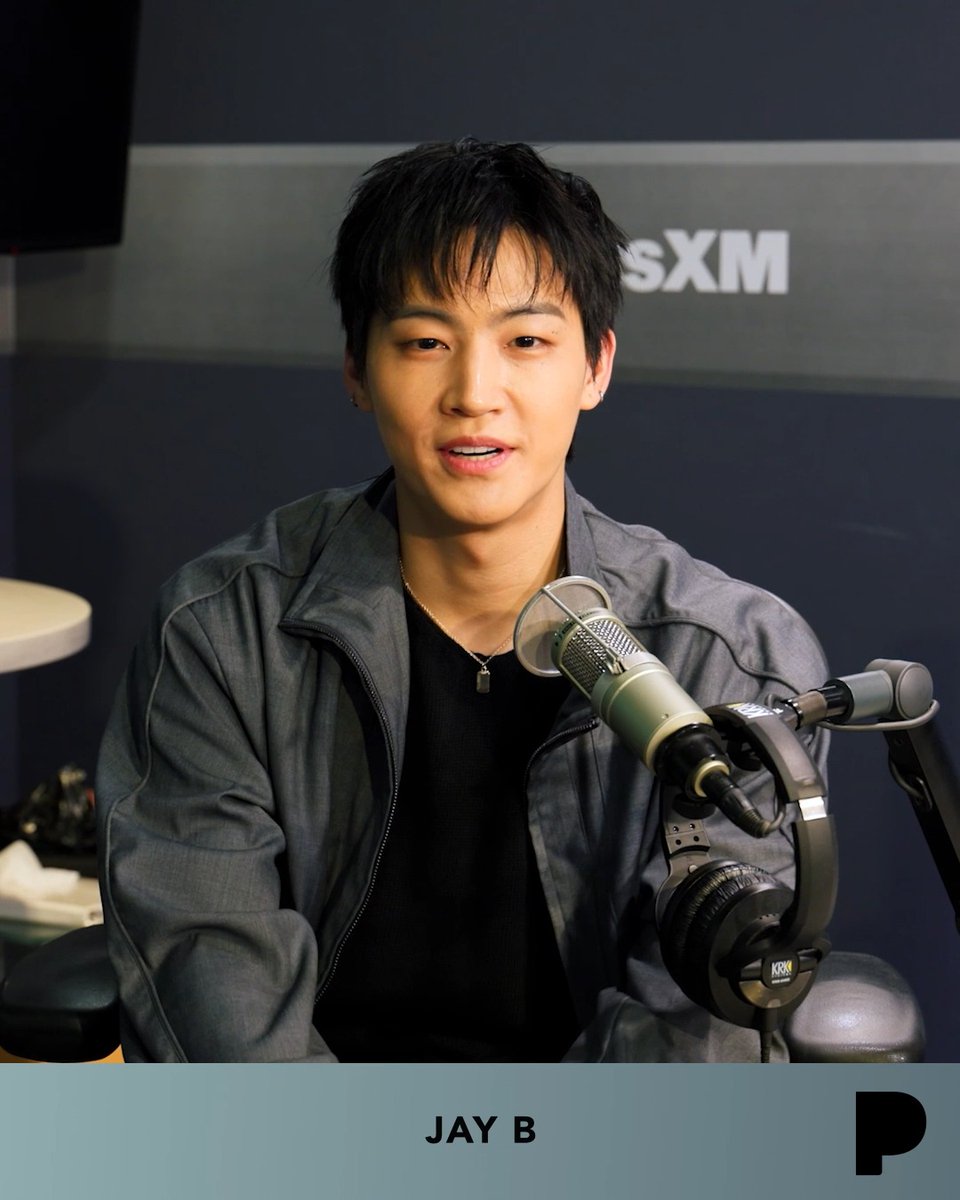 K-pop artist Jay B speaks into a microphone during a SiriusXM radio interview, identified by the 'JAY B' text and People magazine logo at the bottom.