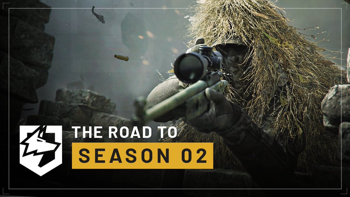 A sniper wearing a ghillie suit aims a rifle through a scope amid rubble and smoke, with the text "THE ROAD TO SEASON 02" displayed alongside a stylized wolf logo—promoting the upcoming second season of Wardogs.