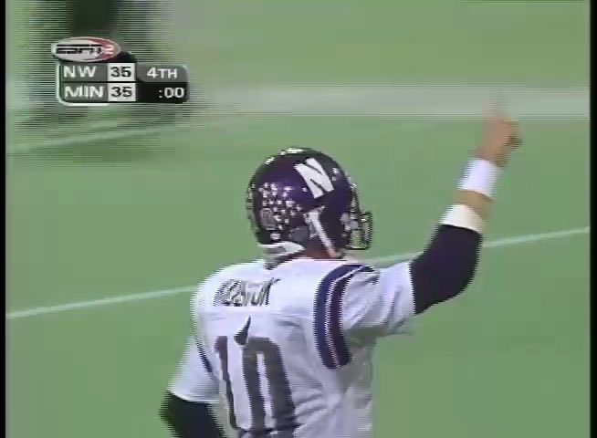 A vintage broadcast screenshot shows Northwestern Wildcats quarterback #10 raising his arm in celebration with the scoreboard reading 'NW 35, MIN 35' in the 4th quarter at :00.