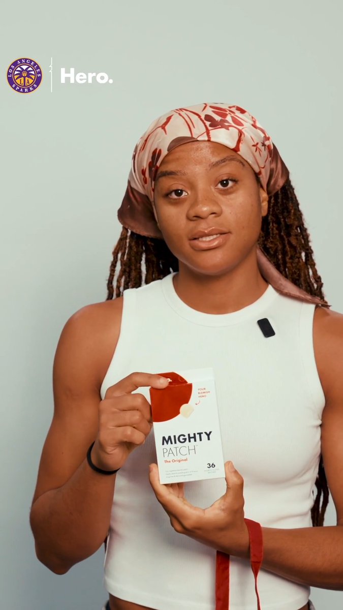 A woman wearing a pink patterned durag and white tank top holds a box of Mighty Patch pimple patches, with "Los Angeles Sparks Hero." branding displayed in the upper left corner.