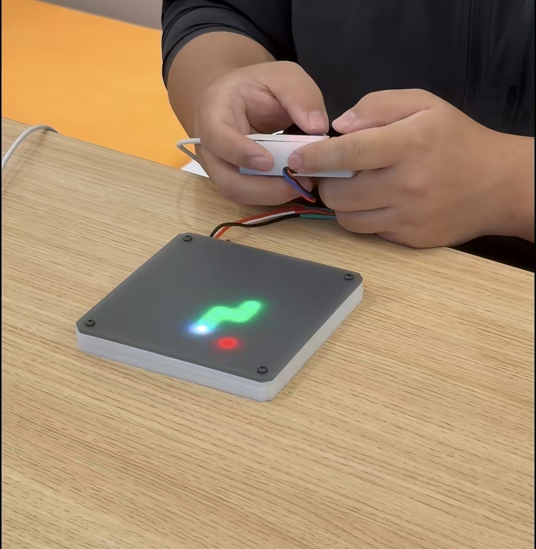 IterxAI's tweet photo. What if you could build a piece of hardware just by describing what you want?

That's the idea behind IterxAI, or 词元开物.

We've seen AI turn simple prompts into websites, apps, and working code. But what about physical devices? What if you could go from an idea to a real circuit board without spending days learning different tools?

That's what we're building IterxAI to do.

Let's try something simple: I want to make a Snake game.

I start with just that one sentence. IterxAI asks a few questions to figure out what I need, then turns my idea into a set of product requirements. It also selects suitable components from its built-in library and brings their functions and connections together in one project.

Next, it generates the code for the game. I can even simulate the code online to see how it runs before moving on to the hardware.

Now comes the interesting part: the PCB.

IterxAI can generate the circuit board design and automatically route the connections. If I want to make changes, I can open the visual editor and move things around, much like drawing on a canvas.

Once the design is ready, I can generate the manufacturing files and send them to a desktop PCB printer.

The printer mills the circuit traces, drills the holes, and cuts out the board. It can even work on both sides of the PCB, giving us more room to build.

And in about ten minutes, we can turn a digital design into a physical circuit board.

Think about what that changes.

Normally, building a hardware prototype means switching between design software, writing code, preparing manufacturing files, and waiting for a board to arrive. If something goes wrong, you may have to repeat the whole process.

With IterxAI and a desktop PCB printer, much of that process can happen right on your desk. You can make a change, print another board, and test it again.

And once we connect the power, the project comes to life.

It started with one sentence. Now, we have a real piece of hardware in our hands.

That's what IterxAI is all about: making hardware creation more accessible, so more people can turn their ideas into things they can actually build.

We're IterxAI, and we're making hardware creation something more people can experience for themselves.