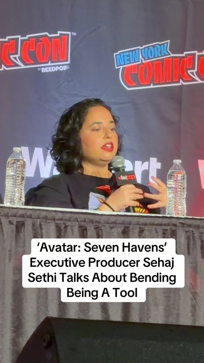 A woman with curly hair and red lipstick speaks into a "Feed Pop" microphone at a New York Comic Con panel, identified by a caption as Sehaj Sethi, Executive Producer of "Avatar: Seven Havens," discussing the role of bending in the series. The post's comment "Ah so thats why everyone is Indian now" humorously reacts to the reveal of an Indian executive producer behind the Avatar animated sequel.