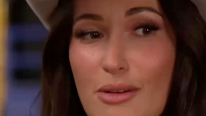 A close-up shot of a woman with dark hair and a nose piercing, appearing to be in the middle of an interview or conversation, likely representing one of the artists mentioned, possibly Kacey Musgraves or Miranda Lambert, as they discuss their collaboration with Anthony Mason on CBS.