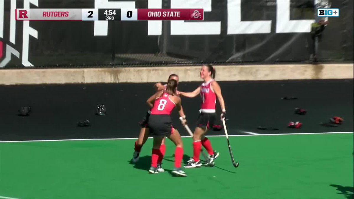 A still from a field hockey game between Rutgers and Ohio State, with Rutgers leading 2-0 in the 3rd quarter (4:54 remaining), showing players in red uniforms celebrating on the field.