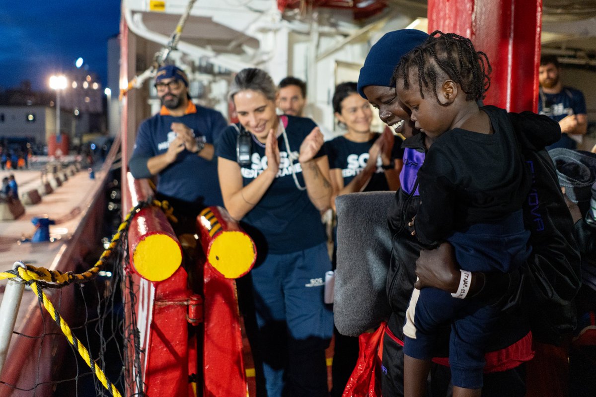 SOSMedIntl's tweet photo. All 99 survivors, including 29 minors and 27 women, have safely disembarked in #Naples. Three days ago, #OceanViking teams rescued 101 people from two rubber boats in distress after days and nights at sea. A pregnant woman was evacuated to Lampedusa, accompanied by her husband. https://t.co/RgYkJAjLXI