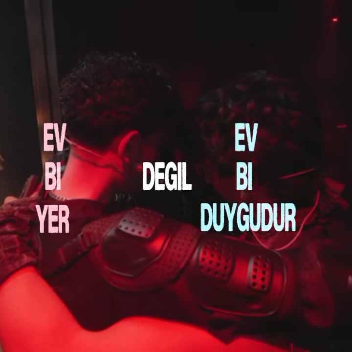 A dark red-tinted image of a person in tactical gear with overlaid text reading 'EV BI YER', 'DEGIL', 'EV BI', and 'DUYGUDUR'.