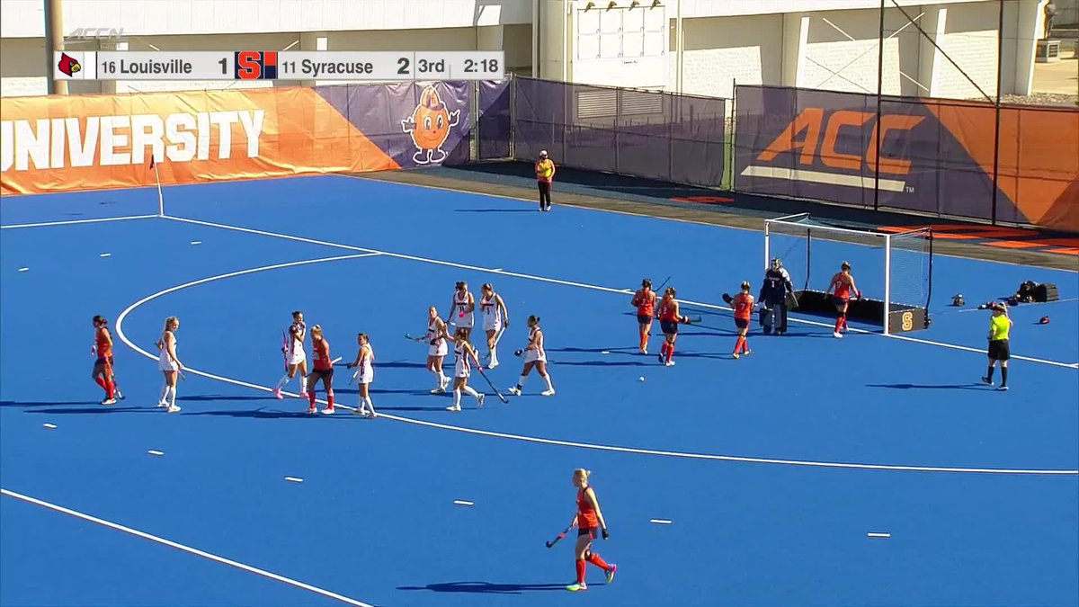 A field hockey game between Louisville (#16) and Syracuse (#11) on a blue turf field, with Syracuse leading 2-1 in the 3rd quarter with 2:18 remaining, sponsored by ACCN/Syracuse University.