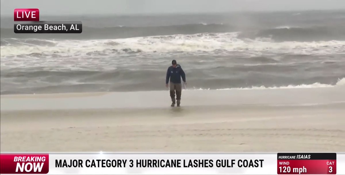 Meteorologist Reynolds Wolf stands on the shore in Orange Beach, AL during a live broadcast as Hurricane Isaias, a Category 3 hurricane with 120 mph winds, lashes the Gulf Coast.