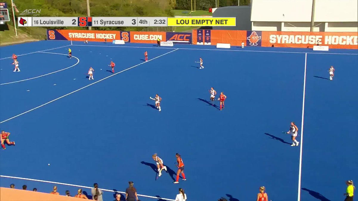 A broadcast screenshot of a women's field hockey match on a blue turf field, with the scoreboard reading "16 Louisville 2, 11 Syracuse 3" in the 4th quarter with 2:32 remaining and Louisville's net empty.