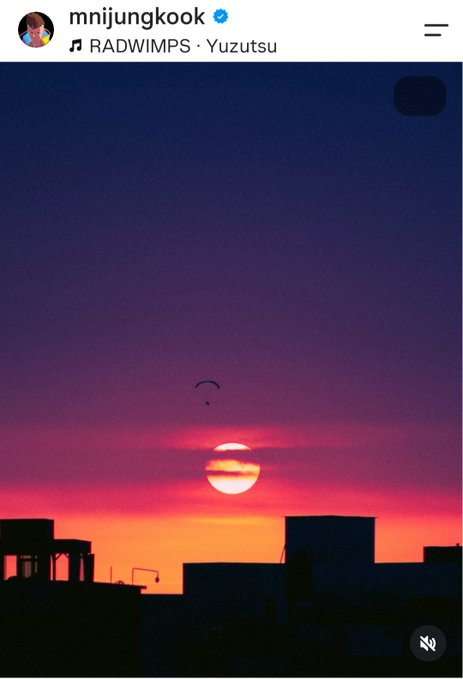 An Instagram story screenshot from 'mnijungkook' featuring a sunset over a city skyline with the song 'Yuzutsu' by RADWIMPS playing.