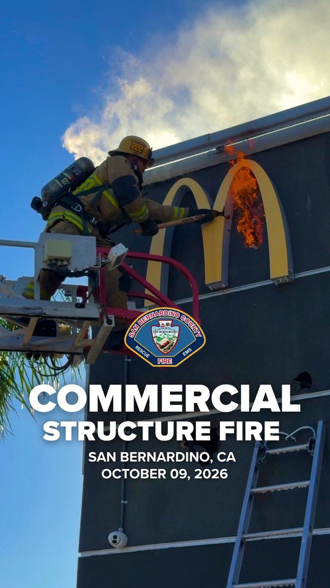 A San Bernardino County firefighter on an aerial ladder extinguishes flames on the golden arches of a McDonald's sign, with text reading "COMMERCIAL STRUCTURE FIRE, SAN BERNARDINO, CA, OCTOBER 09, 2026," illustrating the incident mentioned in the post where crews responded to a fire at the iconic restaurant.