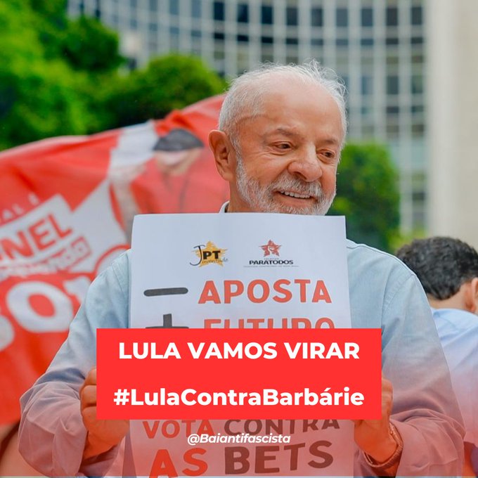 A man holding a campaign sign that reads 'APOSTA NO FUTURO' and 'VOTA CONTRA AS BETS', with overlaid text 'LULA VAMOS VIRAR #LulaContraBarbárie @Baianifascista'.
