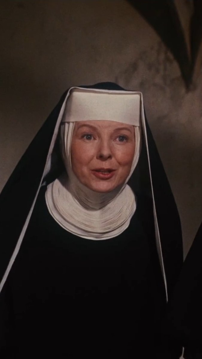 Close-up of a nun wearing a traditional black and white habit, appearing to be from a classic film.