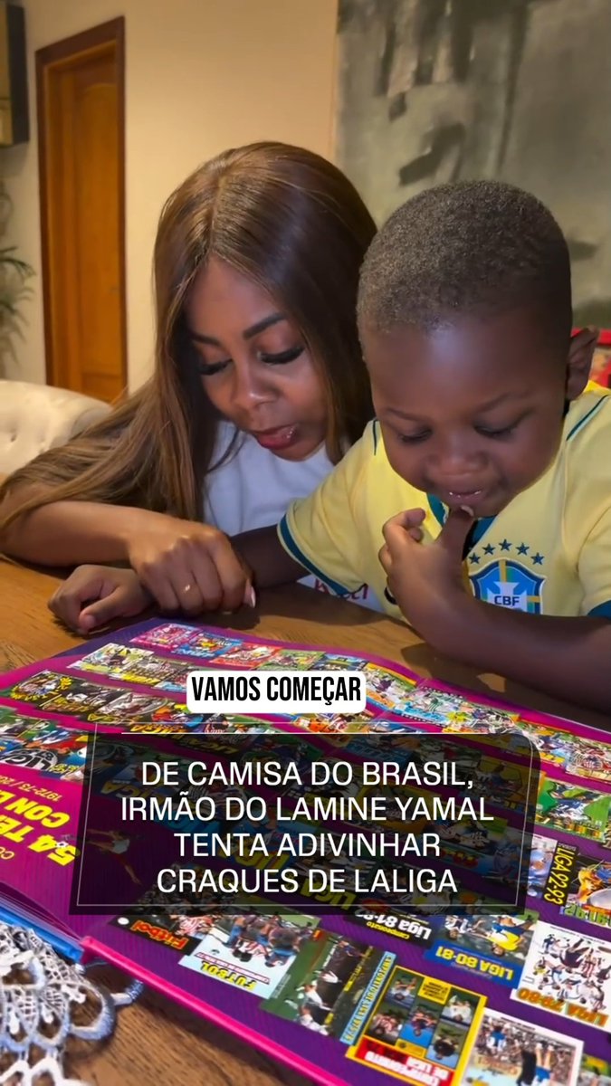 A woman and a young boy wearing a Brazil CBF jersey sit together at a table looking at what appears to be a La Liga-themed magazine or poster. The image features Portuguese text including "VAMOS COMEÇAR" and "DE CAMISA DO BRASIL, IRMÃO DO LAMINE YAMAL TENTA ADIVINHAR CRAQUES DE LALIGA," suggesting the boy is Lamine Yamal's brother attempting to guess La Liga star players.
