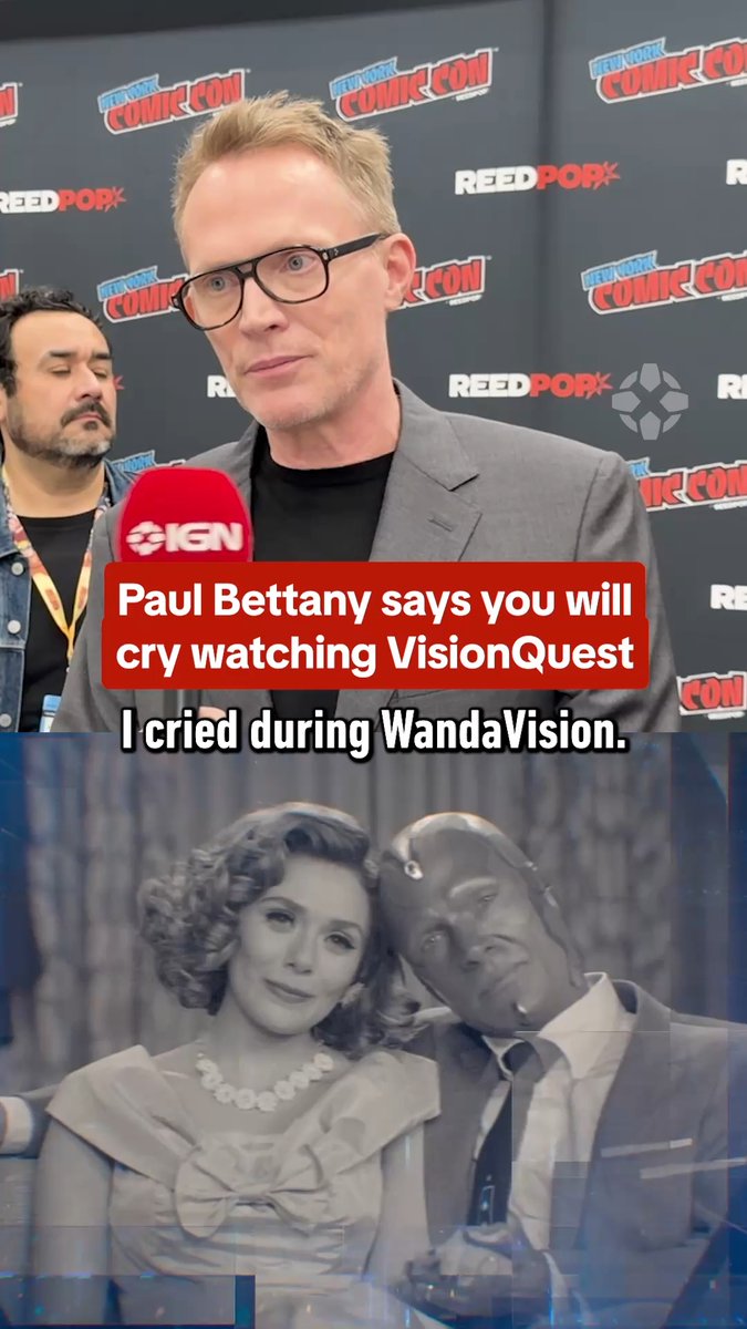 The image shows Paul Bettany at New York Comic Con with an IGN microphone, with text overlay reading "Paul Bettany says you will cry watching VisionQuest" and "I cried during WandaVision," alongside a black-and-white throwback photo of him as Vision with Wanda (Elizabeth Olsen) from WandaVision, relating to the post about his emotional comments on VisionQuest at NYCC.