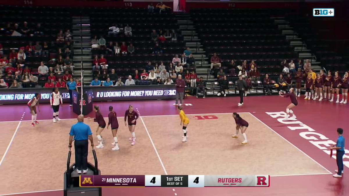 A women's college volleyball match between Minnesota and Rutgers, tied 4-4 in the first set, with players in maroon uniforms on the court.