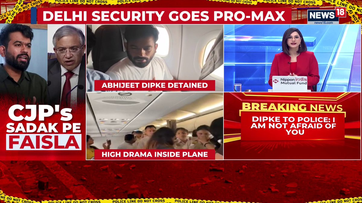 A News18 broadcast titled "Delhi Security Goes Pro-Max" displays a multi-panel layout showing a detained Abhijeet Dipke on a plane with the caption "High Drama Inside Plane," alongside a news anchor and two commentators, while a "Breaking News" banner reads "Dipke to Police: I Am Not Afraid of You." The on-screen graphics align with the post's focus on heightened security tensions in Delhi, featuring hashtags related to the Delhi Police, Delhi Airport, and the incident.