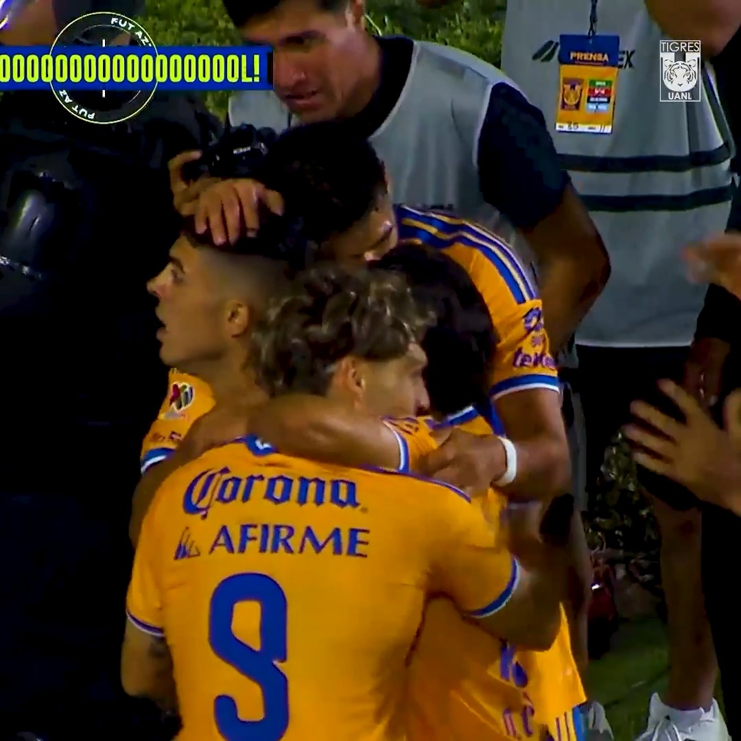 Tigres players in their yellow and blue "Corona" and "Afirme" sponsored jerseys celebrate a goal, with "GOOOOL!" displayed on screen alongside the Tigres UANL logo, marking one of the three goals in their 3-2 Apertura 2026 victory over Toluca.
