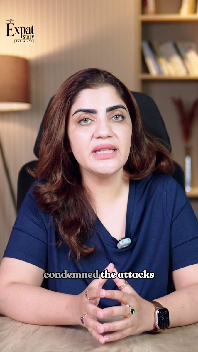 A woman in a blue top speaking in a video for 'The Expat Story Explainer' with the caption 'condemned the attacks' displayed on screen.