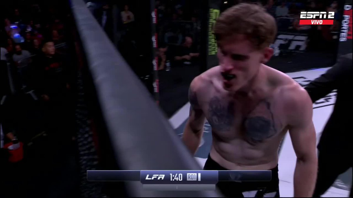 A screenshot from an ESPN2 broadcast of an MMA fight showing a shirtless fighter with reddish hair and chest tattoos yelling, with the overlay text 'LFA 1:40 RD 1'.