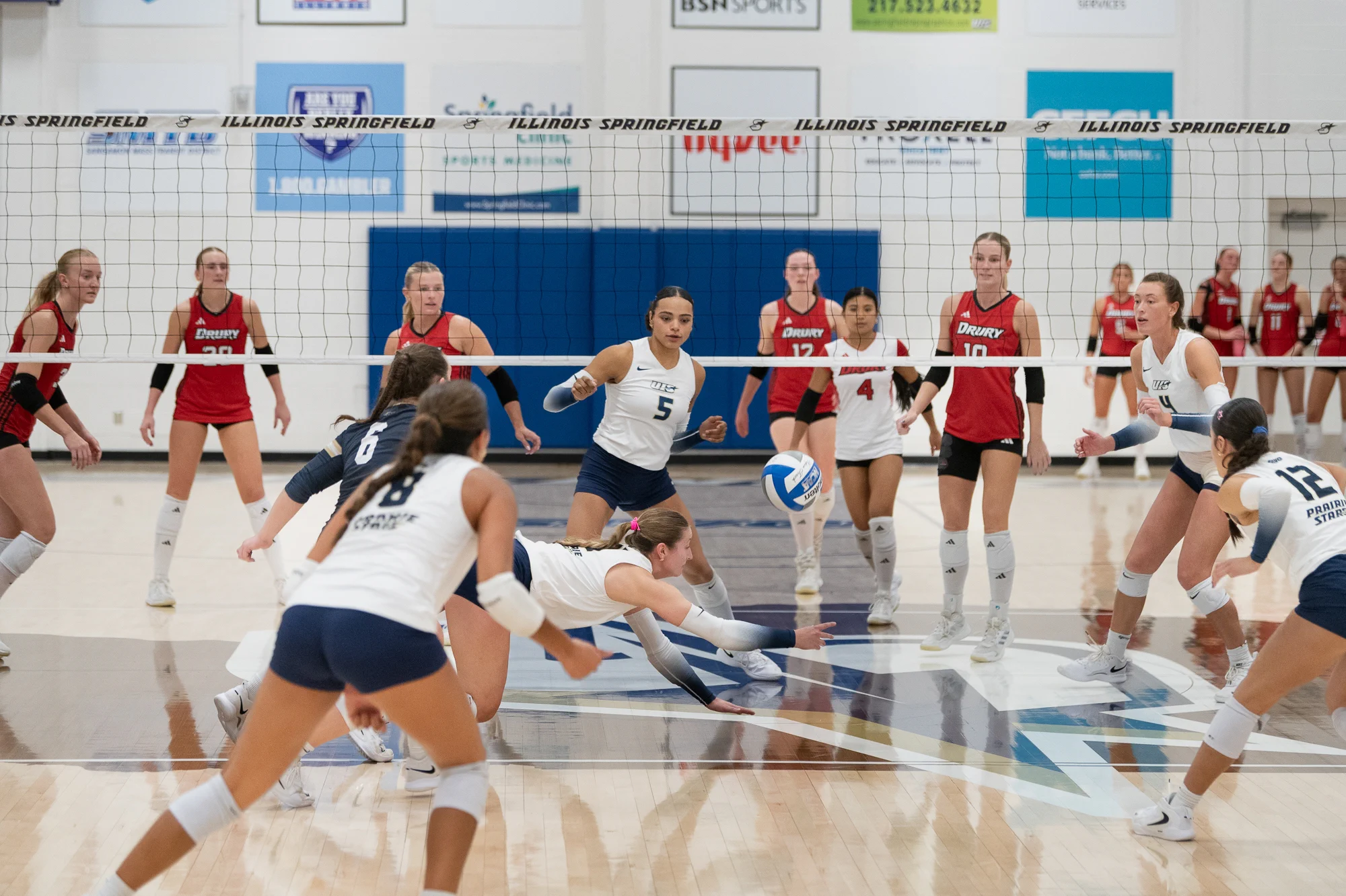 A UIS volleyball player dives to reach the ball during a match against Drury University.
