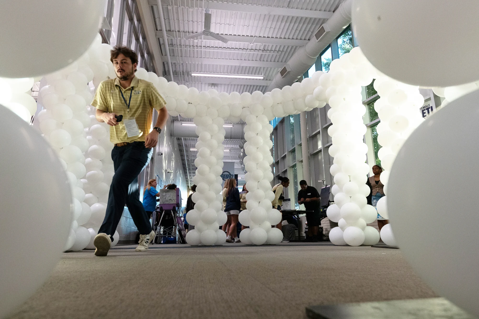 A large white balloon colonnade fills a hallway at UIS during Homecoming festivities.