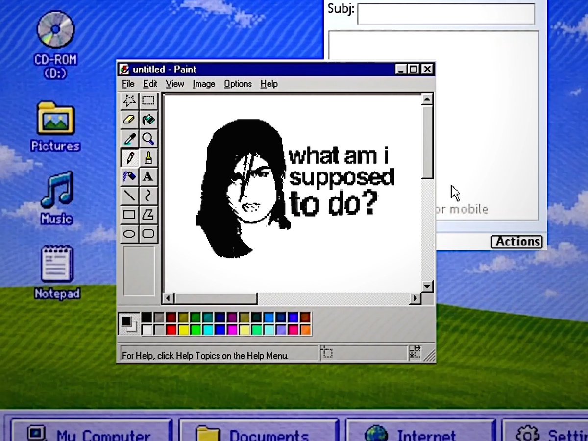 A nostalgic Windows XP 'Bliss' desktop screenshot featuring MS Paint open with a pixelated black-and-white drawing of a woman's face and the text 'what am i supposed to do?', surrounded by classic icons like CD-ROM, Pictures, Music, and Notepad.