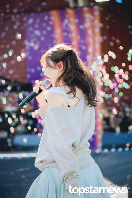 Wendy of Red Velvet sings on stage at the 2026 GHOST Festival, with colorful bokeh lights creating a festive backdrop. The watermark "topstarnews" appears in the bottom right corner of the HD preview photo.