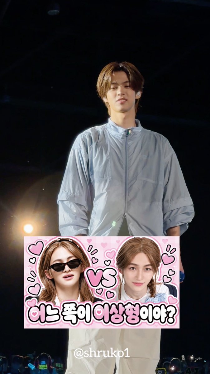 A young man with brown hair wearing a light blue jacket and an in-ear monitor stands on stage against a dark background with stage lights. Overlaid at the bottom is a pink graphic featuring two people in a "VS" comparison with hearts and Korean text reading "어느 쪽이 이상형이야?" (Which one is your ideal type?), and the caption "@shruko1" — matching a post about choosing Kim Yeo-joo in an ideal-type comparison.