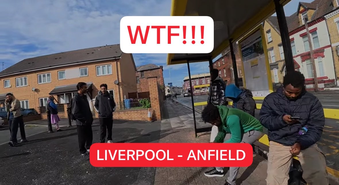 A YouTube-style thumbnail displays the text "WTF!!!" above a red banner reading "LIVERPOOL - ANFIELD," with the split image showing a residential street on the left where people are standing outside, and a bus stop on the right with individuals waiting, used to visually support a claim about demographic change in the Liverpool area.