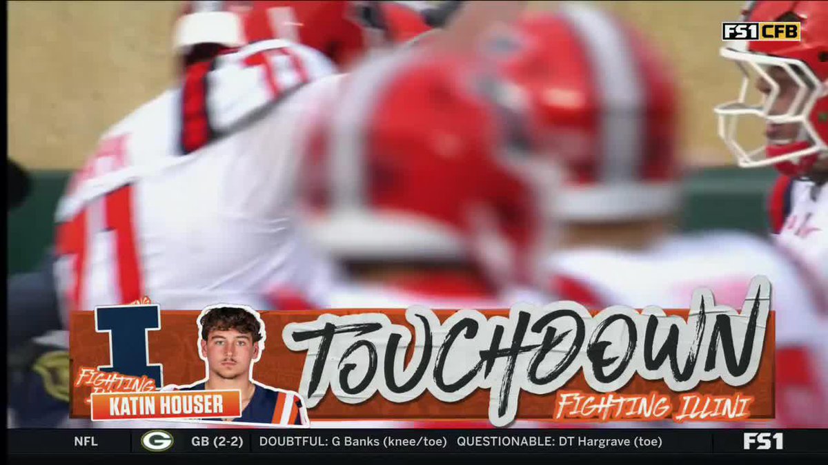 A screenshot from an FS1 college football broadcast showing a "TOUCHDOWN" graphic for "KATIN HOUSER" of the "I" Fighting Illini, with the ticker at the bottom showing NFL news about GB including "DOUBTFUL: G Banks (knee/toe)" and "QUESTIONABLE: DT Hargrave (toe)."