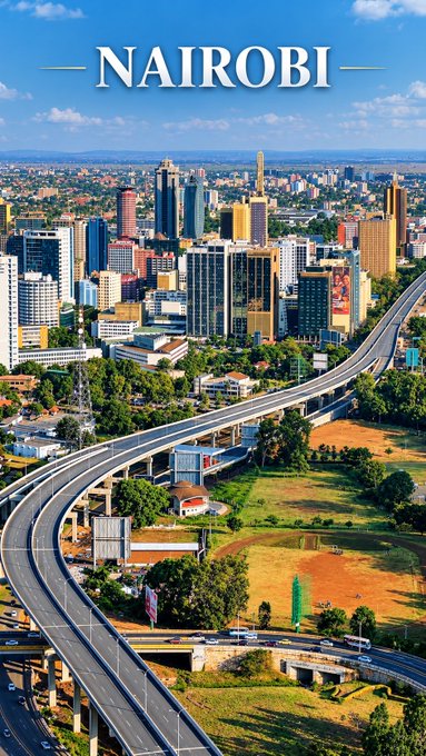 An aerial cityscape of Nairobi with skyscrapers and an elevated highway under a blue sky.