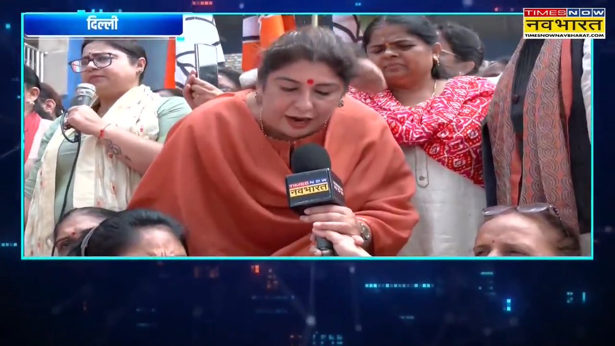 A news broadcast screenshot from 'TIMES NOW नवभारत' showing an emotional woman in an orange sari speaking into a microphone in Delhi, surrounded by other women supporters.