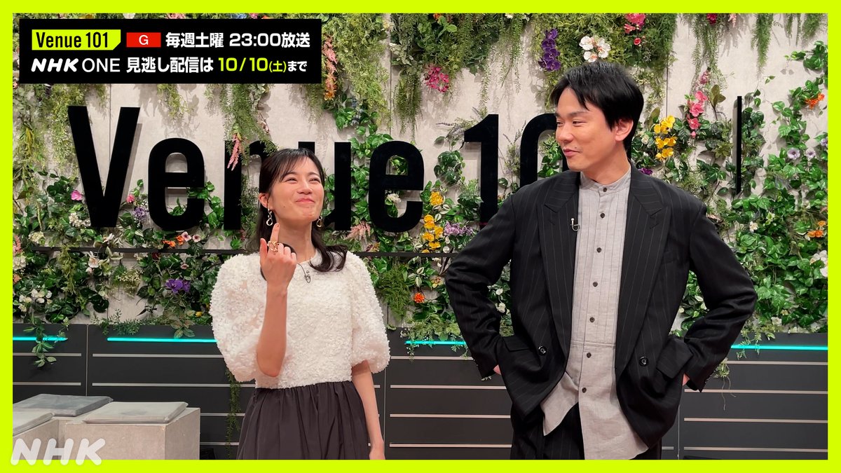 A Japanese TV promotional image for 'Venue 101' on NHK ONE, featuring two presenters standing in front of a floral 'Venue 101' backdrop, with text indicating Saturday 23:00 broadcasts.