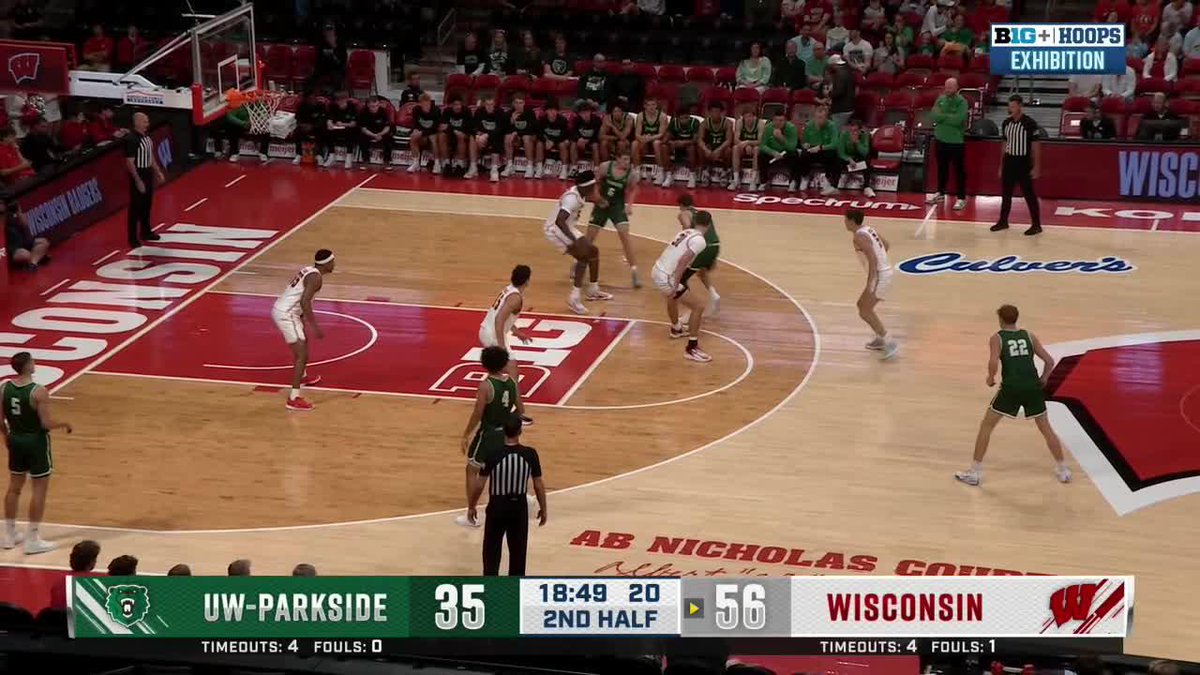 Wisconsin (Big Red) leads UW-Parkside 56-35 in a 2nd half exhibition matchup, as a player at center court prepares to drive past his defender toward the hoop. The scoreboard confirms the Badgers' dominant lead with 18:49 remaining, supporting the caption's celebration of another "big slam."