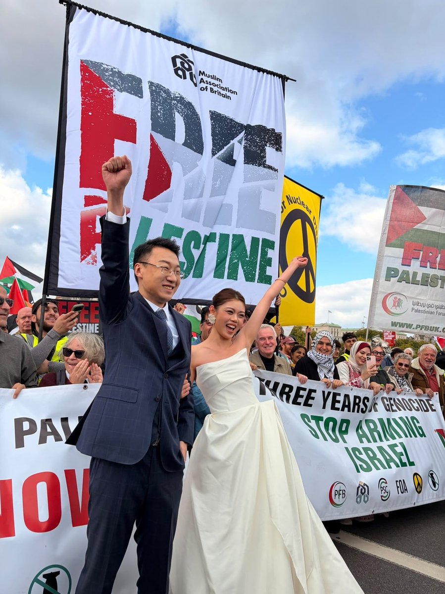 AlanRMacLeod's tweet photo. Pic of the day: a couple in London take time away from their wedding to show their support for a free Palestine. (Oct. 10, 2026) https://t.co/Ut5HUbUcyj