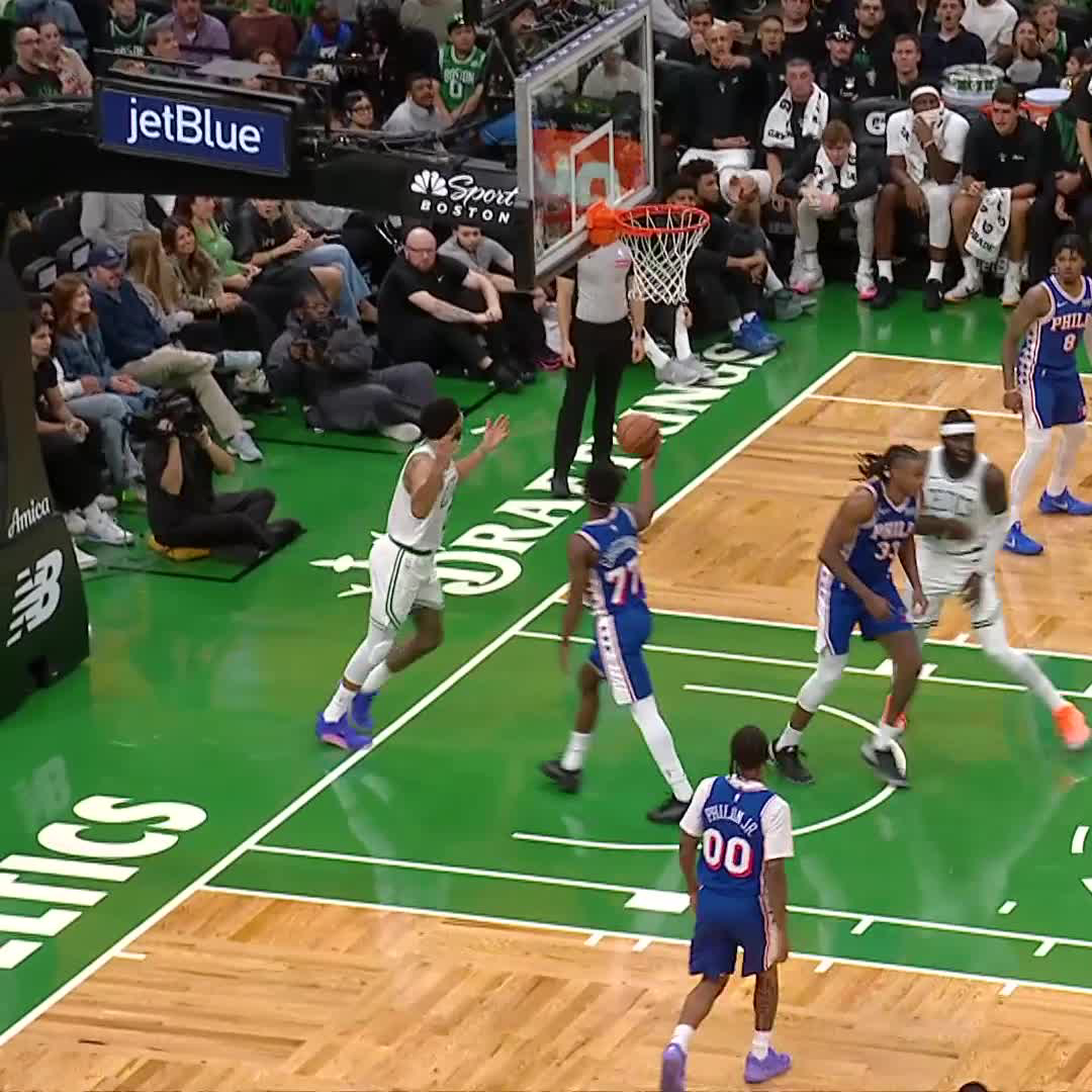 A basketball game between the Boston Celtics and Philadelphia 76ers, with a Celtics player driving to the basket.