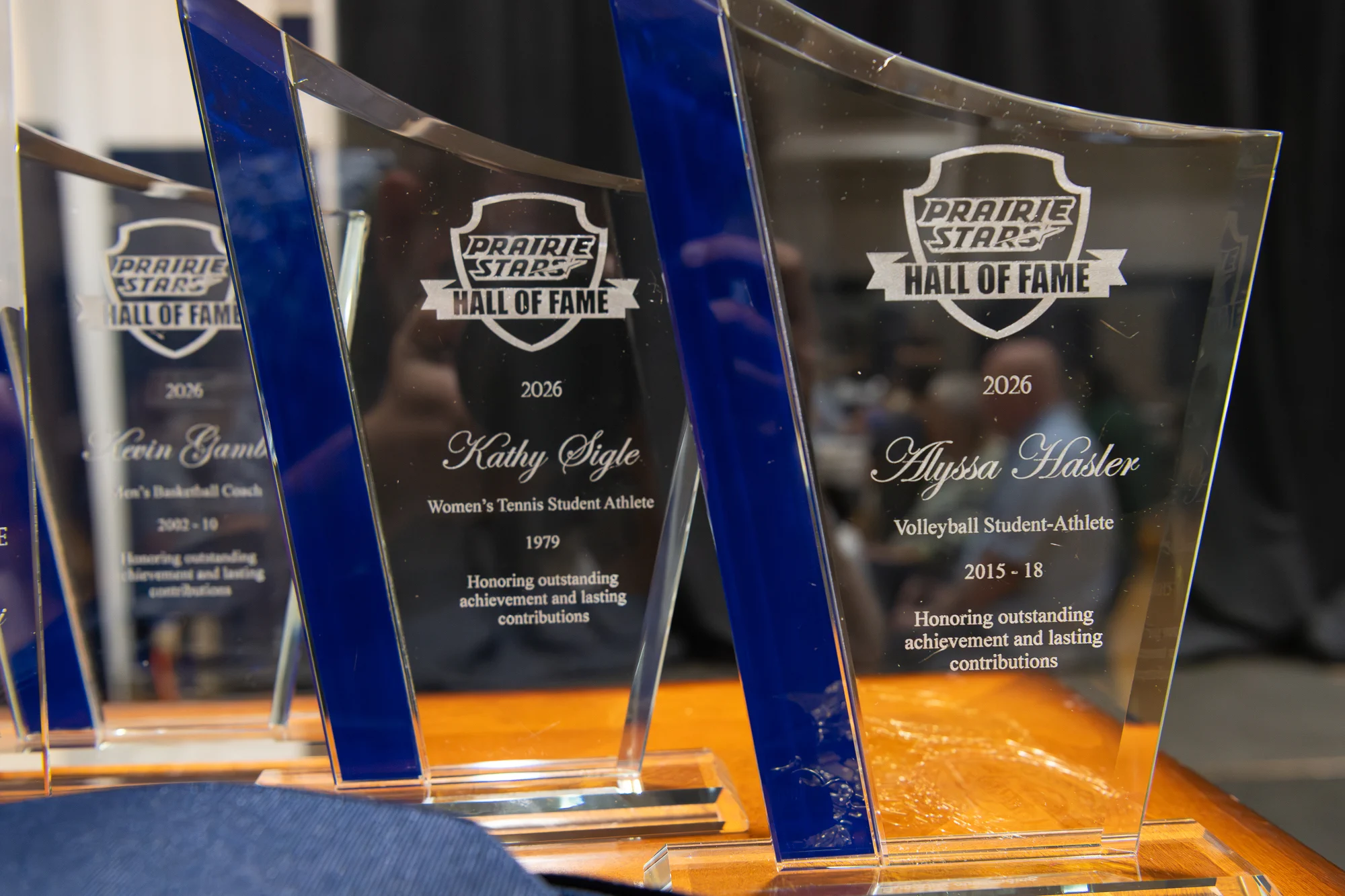 Prairie Stars Hall of Fame awards honoring Kathy Sigle, Alyssa Hasler and Kevin Gamble are displayed.