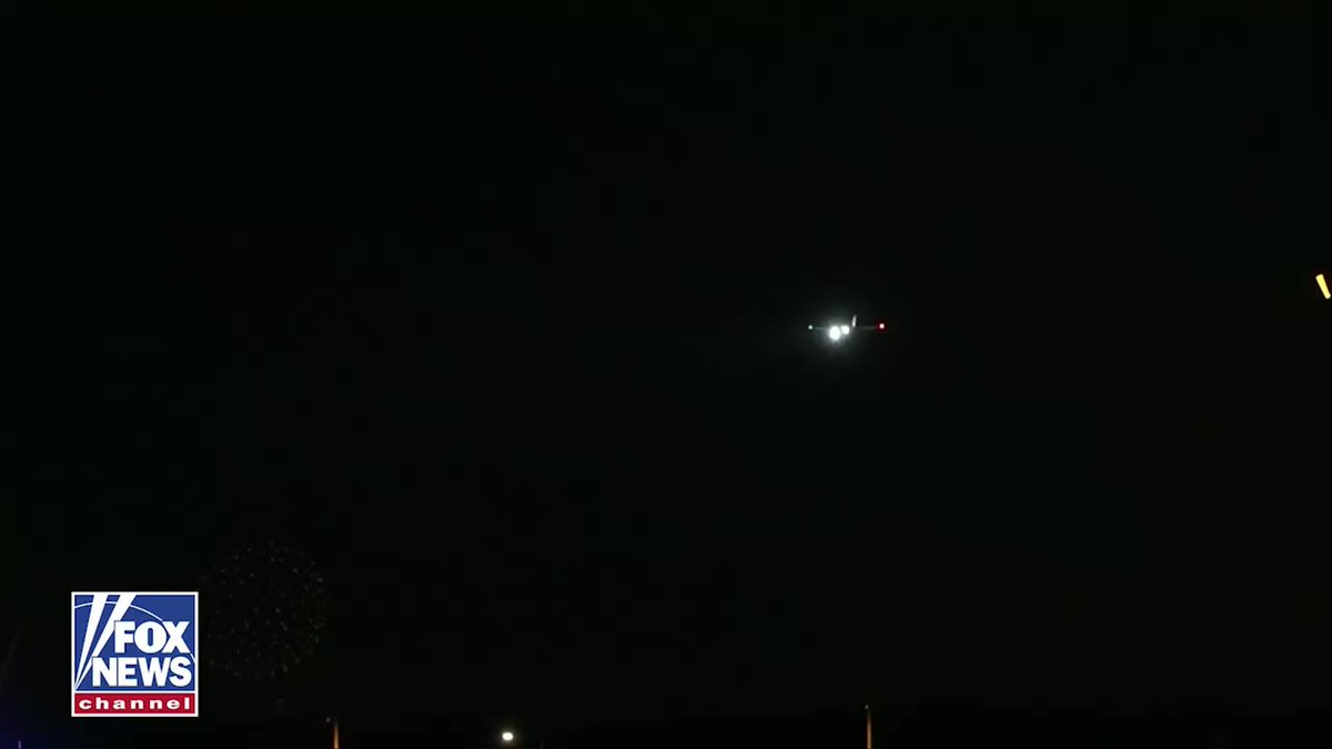 Air Force One, with its distinctive lights illuminated, is captured descending through the dark night sky over Washington, D.C., as shown in the Fox News broadcast. The image aligns with the post's description of the president returning to the nation's capital after a midterm rally, though fireworks are not visible in this particular frame.