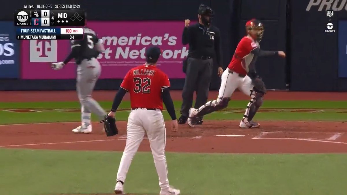 Pitcher Gavin Williams (#32) stands on the mound having just thrown a 100 MPH four-seam fastball to Munetaka Murakami, with the ALDS scoreboard showing Game 1 tied 0-0 in the middle of the 4th inning of the best-of-5 series between the White Sox and Guardians. The umpire signals a strikeout as the catcher rises from his crouch, highlighting Williams' strong start with 9 strikeouts through four innings.