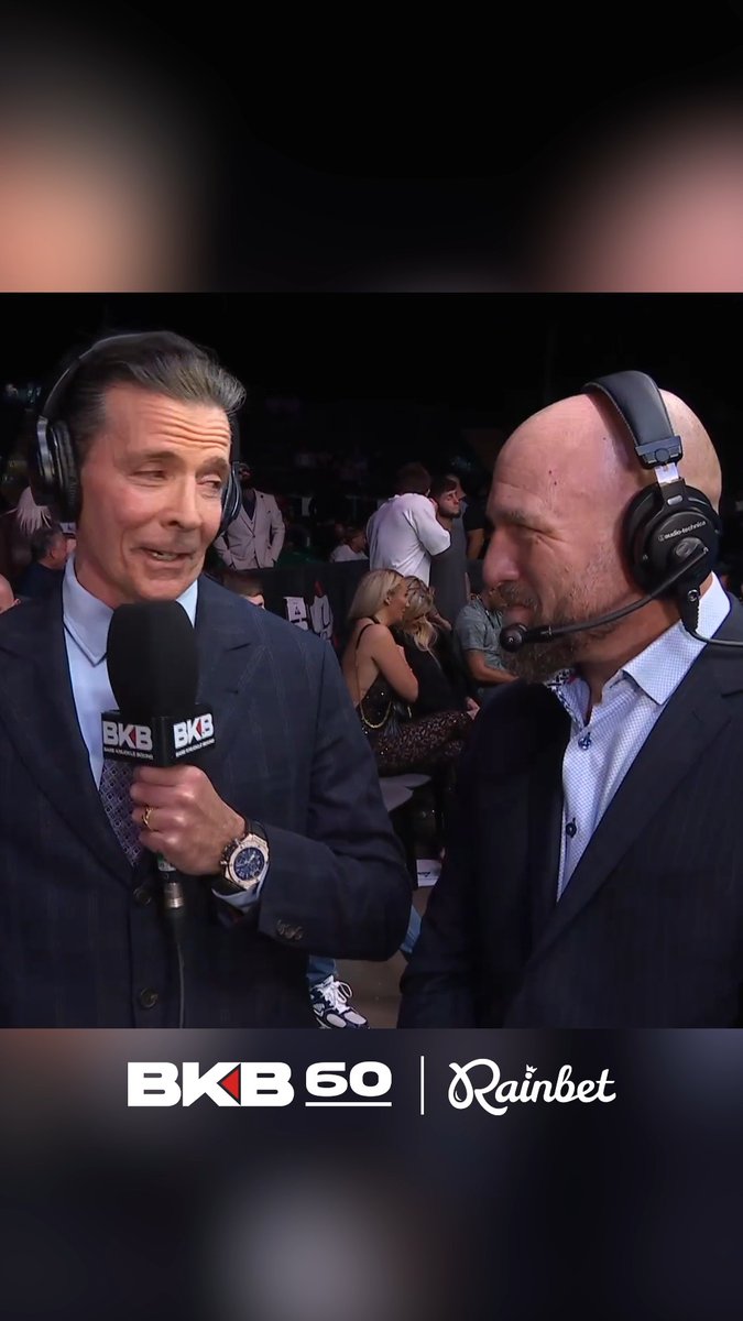 Two broadcasters wearing headsets speak into microphones at a BKB event, sponsored by Rainbet.