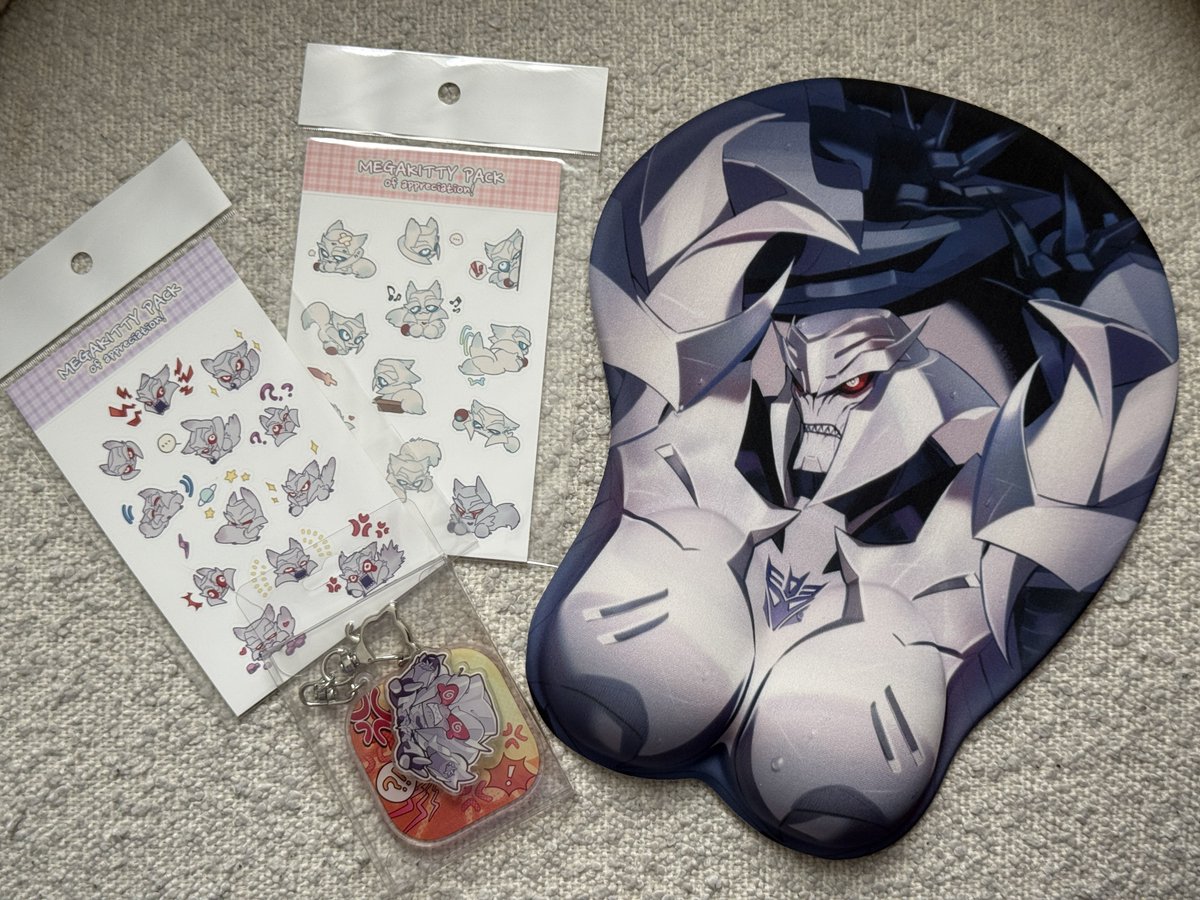LandeDerGelande's tweet photo. This is so funny! I think Megatron is a great character. I enjoy funny trinkets, internet jokes, and art.

When I ordered the Megatron mousepad from @___030______abs I also received these Megakitty stickers and this acrylic Megatron keychain.

I am laughing. Thank you so much!!!! https://t.co/ZJ7I1Gwa8q