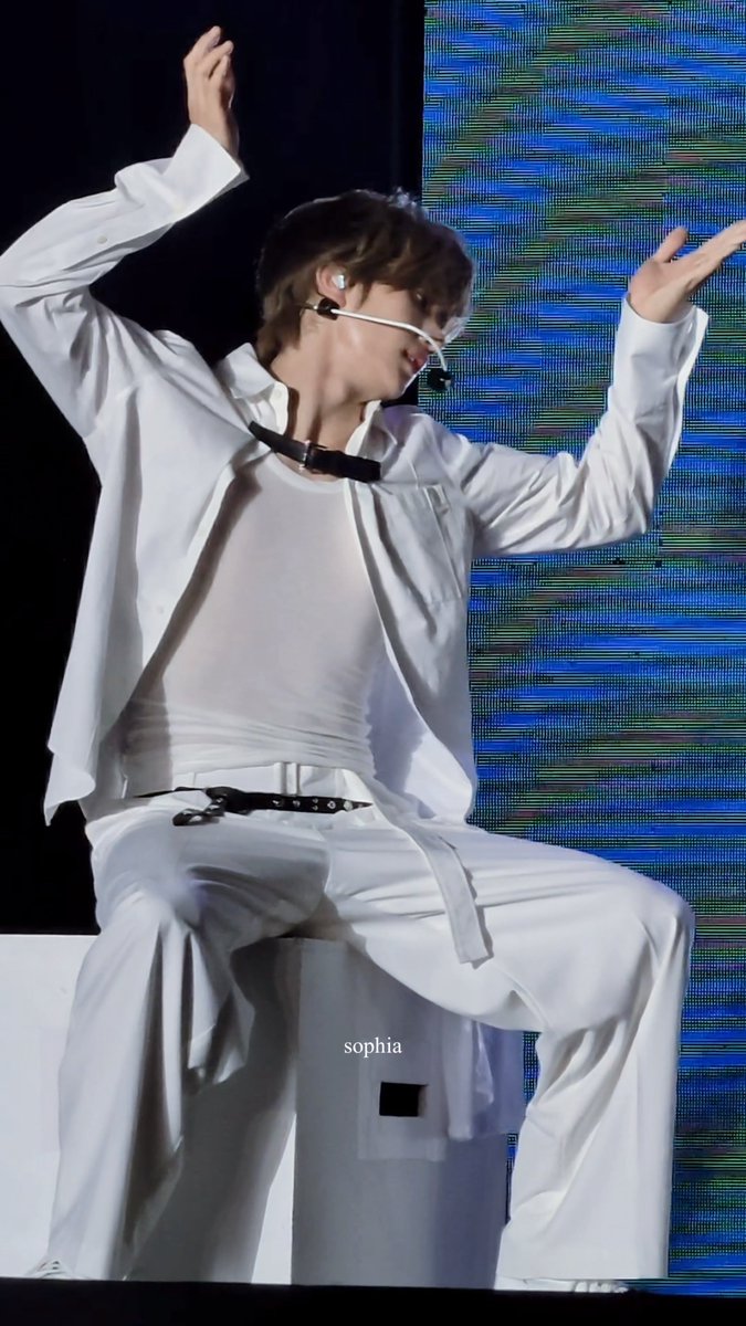 A K-pop performer in an all-white outfit dancing on stage, with the text "sophia" visible as a watermark.