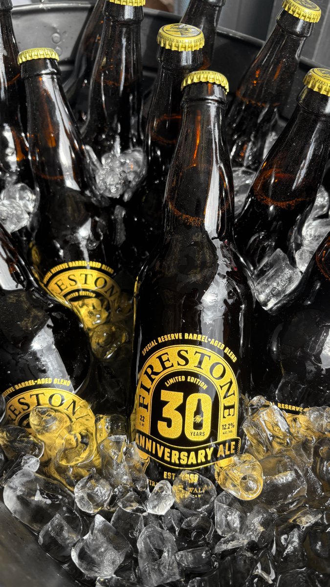 Several bottles of Firestone 30th Anniversary Ale, labeled as a 'Special Reserve Barrel-Aged Blend,' sit chilling in a bucket filled with ice.
