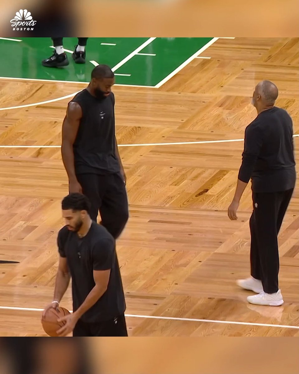 A screenshot from NBC Sports Boston shows Boston Celtics players, including Jayson Tatum and Jaylen Brown, warming up on a wooden basketball court alongside a coach.